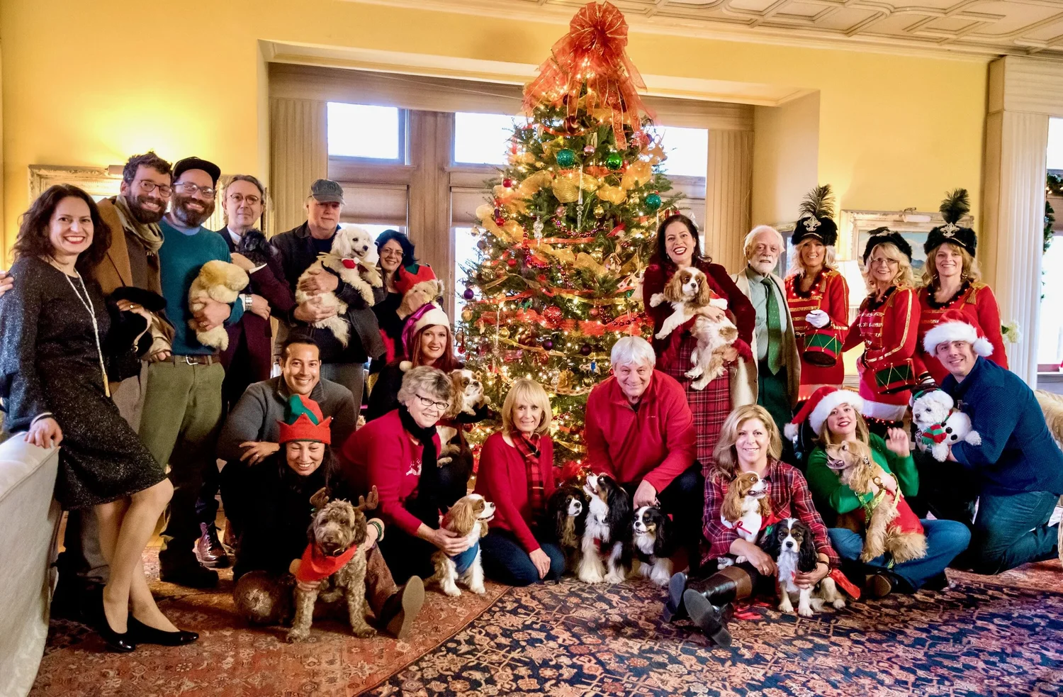 a group of people posing for a photo with a christmas tree