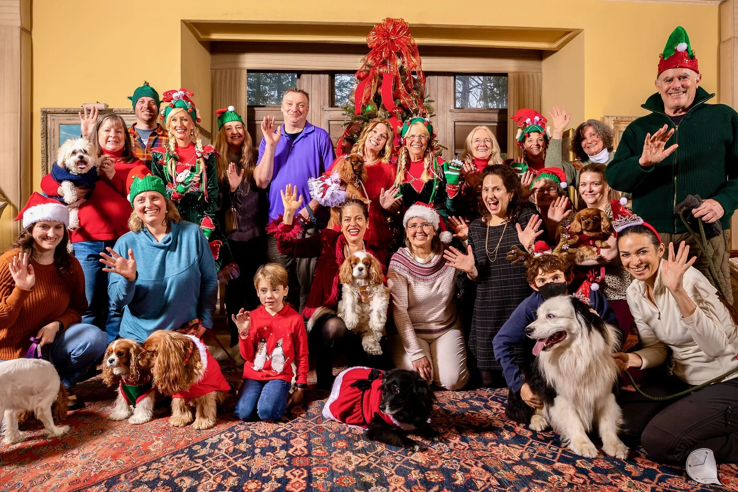 a group of people posing for a photo with dogs