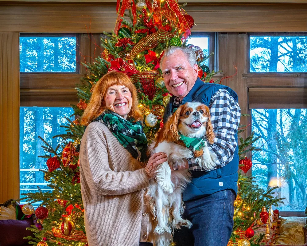 a man and woman holding a dog