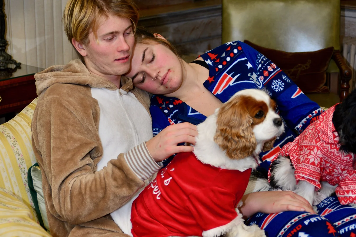 a man and woman holding a dog